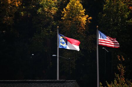 North Carolina and American flag blowing in the breezeの写真素材