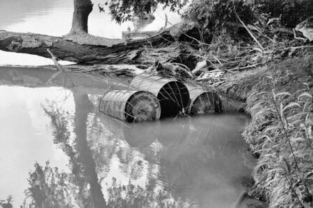 trash floating along the riverの写真素材