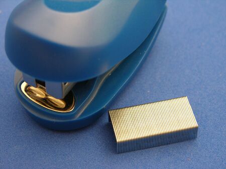           A blue stapler on a blue backgroundの写真素材