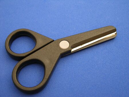 Paper scissors seen up close on a blue backgroundの写真素材