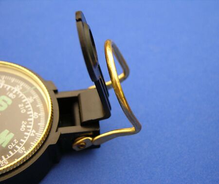           Closeup view of a compass on a blue backgroundの写真素材
