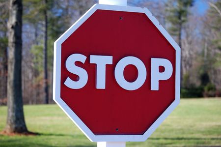 A wooden stop sign shown up closeの写真素材
