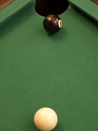 Eight ball ready to be dropped in the cornerの写真素材