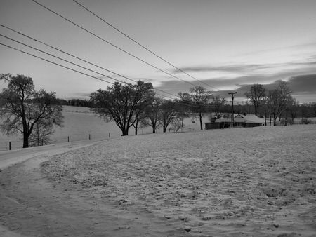 a farm in winter shown in black and whiteの写真素材