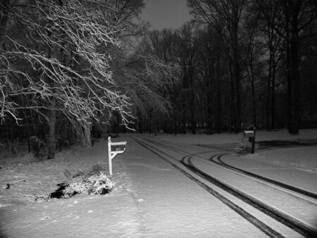 a farm in winter shown in black and white during the nightの写真素材