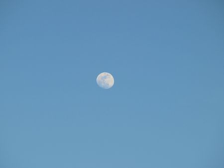 the moon in the early evening before darkの写真素材