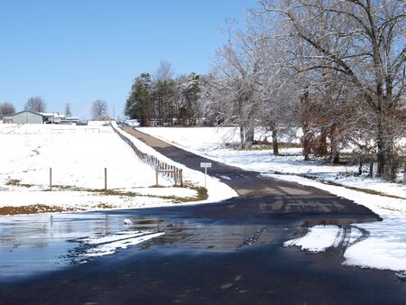 A spring storm melting on a farm roadの写真素材