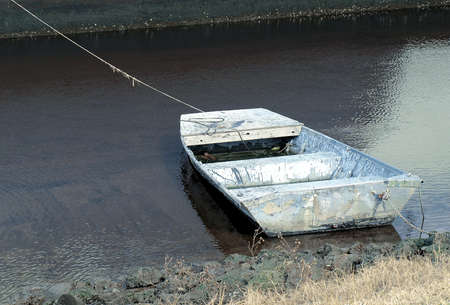 Old boat along the shore in very poor conditionの写真素材