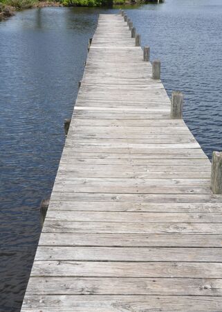 A wooden boat dock ready for use on a warm summer day.の写真素材