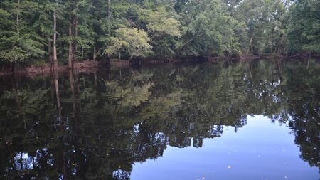 still water of a rural riverの写真素材