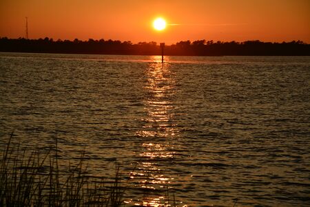 Sunset on the cape fear River during the summer.の写真素材