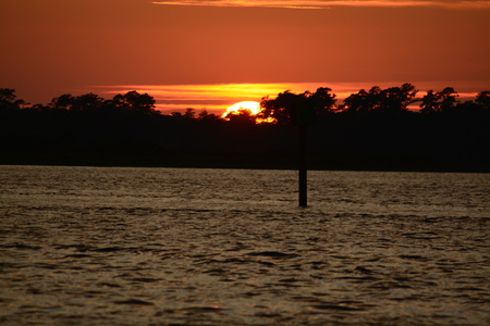 The sun is almost gone on the summer day along the cape fear river in North Carolinaの写真素材