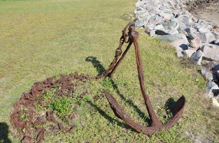 Old rusted anchor along the shore in North Carolinaの写真素材