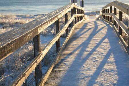 A rare snow and ice storm in Kure Beach North Carolina. The boardwalk is covered with ice and snow.の写真素材