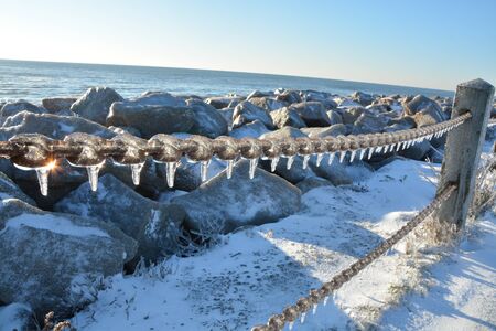 A rare snow and ice storm in Kure Beach North Carolina covers the rocks.の写真素材