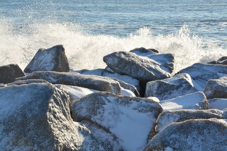 A rare snow and ice storm in Kure Beach North Carolina with waves crashing in.