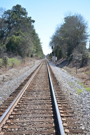 Long strait railroad tracks heading out in the distance.の写真素材