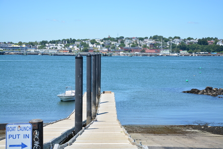 Boat launch in Casco Bay Harbor on warm summer day in Maine.の写真素材