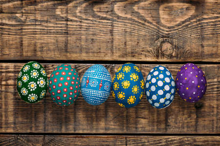 Colorful Easter eggs in a handmade on wooden backgroundの写真素材