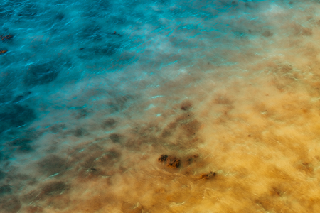 Abstract background of azure and yellow reflections on the waterの写真素材