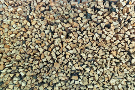 Pile of stacked triangle firewood prepared for fireplace and boiler.