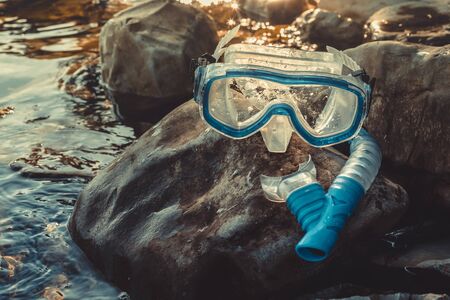 Mask For Diving And Snorkel Tube Lie on The Stones, On The Sandy, Closeup. Tourism Travel Freediving Conceptの写真素材
