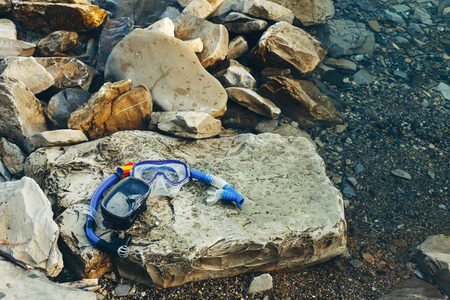 Blue Masks For Diving And Tubes Lie On The Beach, On The Rocks. Tourism And Travel Conceptの写真素材