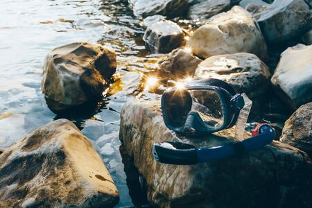 Diving Mask And Snorkel Lie on The Stones, On The Sandy. Tourism Travel Freediving Conceptの写真素材