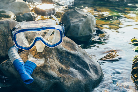 Diving Mask And Snorkel Lie on The Stones, On The Sandy, Closeup. Tourism Travel Freediving Conceptの写真素材