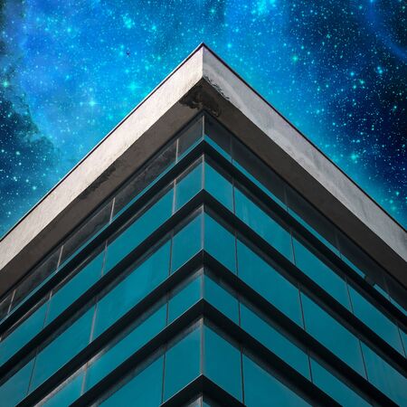 Commercial building exterior ON Star Sky Background. Angle of building glass walls. Concept Of...
