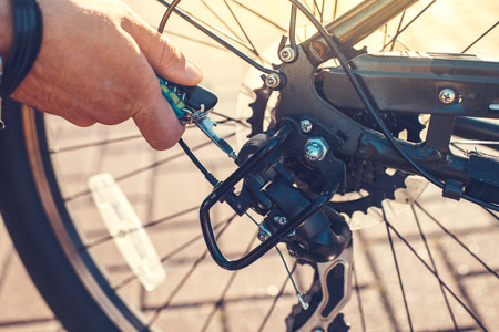Closeup Cyclist Man's Hand Repairing Bicycle Wheelの写真素材