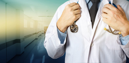 Healthcare and Medicine concept. Unrecognizable Male Doctor Holds Hands On Stethoscope