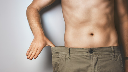 Young Man Shows How Much He Lost Weightの写真素材