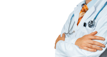Male Doctor In White Coat With A Stethoscope Crosses His Arms Over His Chest Copy-space. Healthcare Medicine Conceptの写真素材
