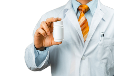 Male Doctor In White Coat Shoulder Holding Bottle Of Pills Between His Fingers. Healthcare Medical Hospital Conceptの写真素材