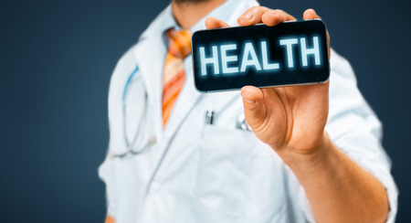 Technology in Health and Medicine Concept. Doctor With Smartphone With Medical Appの写真素材