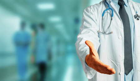 Unrecognizable Man Doctor Holds Out His Hand To Say Hello. Greeting Patient. Healthcare Medicine Conceptの写真素材