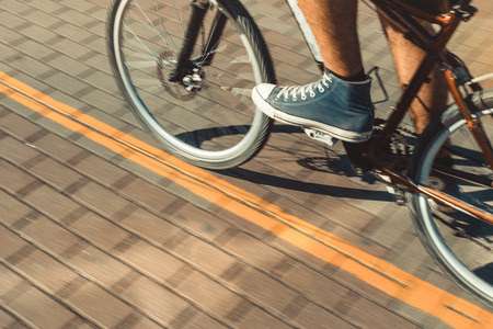 Unrecognizable Cyclist Rides A Bicycle Path Motion Blur. Point Of View Shotの写真素材