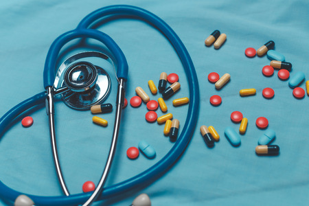Assorted Colorful Pharmaceutical Medicine Pills, Tablets And Capsules Over Blue Backgroundの写真素材