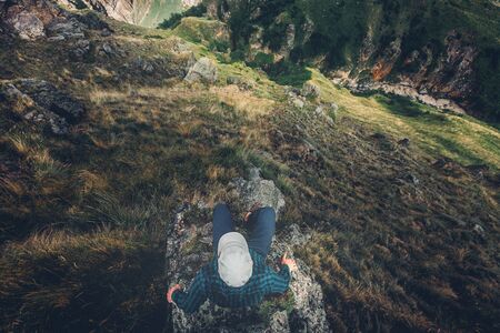 Man Traveler Sitting On Cliff Bridge Edge With Mountains Aerial View Travel Lifestyle Adventure Vacations Conceptの写真素材