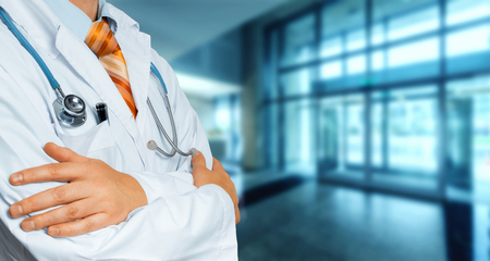 Doctor In White Coat Crosses His Arms Over His Chest Copy-space. Healthcare Medicine Conceptの写真素材
