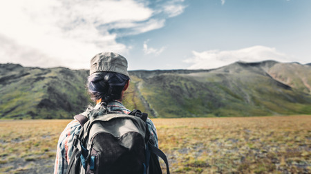 Young Traveler Girl With Backpack Is Engaged In Hiking In Mountains, Rear View. Tourism Adventure Lifestyle Conceptの写真素材