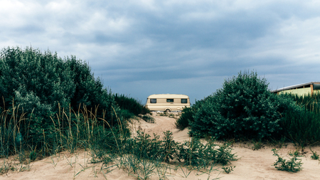 Caravan Camping Trailer On The Sandy Beach. Transportation Rest Journey Outdoor Conceptの写真素材