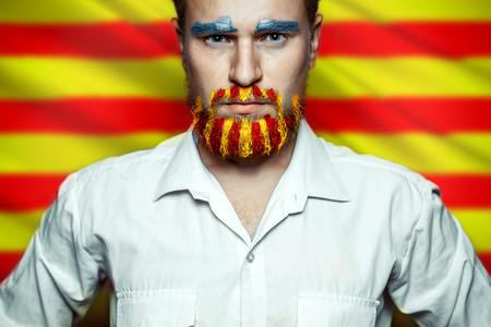 Portrait Of A Stern Man With A beard, Unraveled In Colors Of The Flag Of Catalonia. Referendum For The Separation Of Catalonia From Spain. Democracy Independence Conceptの写真素材