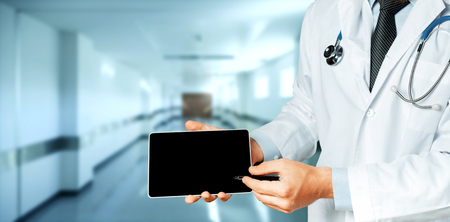 Male Doctor Using Digital Tablet In Consultation With Patientの写真素材