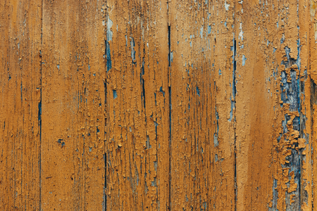 Texture Of Wooden Fence Covered With Yellow Old Paint With Cracksの写真素材