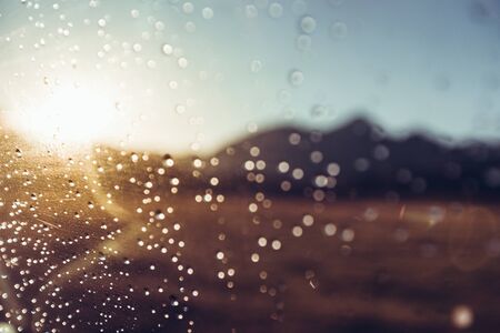 Raindrops On Car's Wind Shield On The Mountains And Sun, Selective Focus. Travel Journey Conceptの写真素材