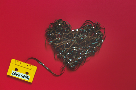 Audio Cassette Tape With The Inscription Love Song On A Red Background. Retro Technology Romance Conceptの写真素材