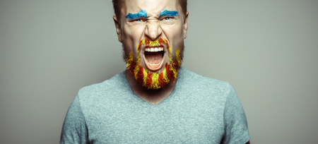 Portrait Of A Cry Man With A beard, Unraveled In Red And Yellow Colors . Referendum For The Separation Of Catalonia From Spain. Democracy Independence Conceptの写真素材