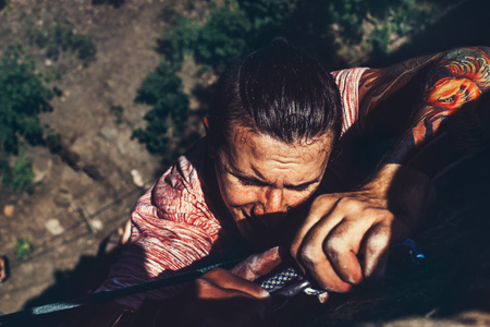 Young Climber Man On The Rock Wall, Close-up Of Male Hands With Tape In Magnesium Powder